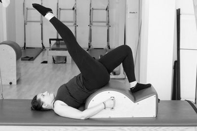 Claire Schapira with the spine corrector on the reformer in the Palma Pilates Studio The Hague
